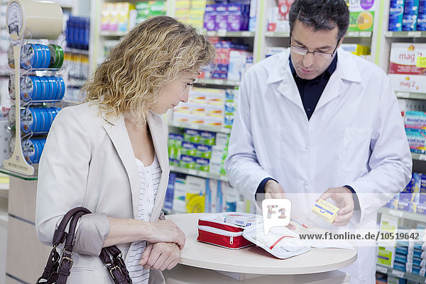 Woman buying a first aid kit in a pharmacy.