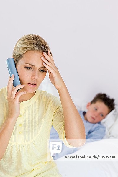 Ill boy and mother on telephone