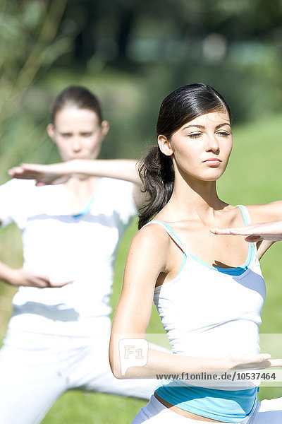 Young women exercising in park