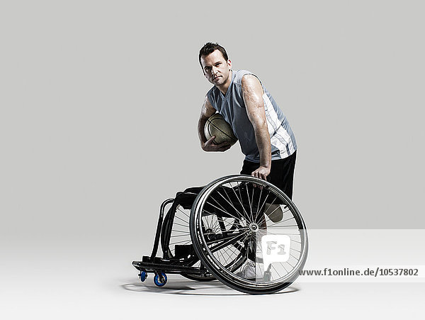 Basketball player with ball and wheelchair