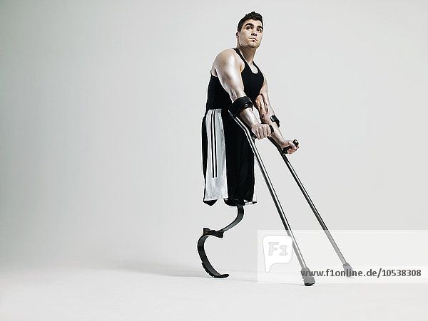 Man with crutches and prosthetic leg