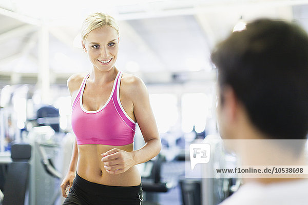 Smiling woman working out in gym