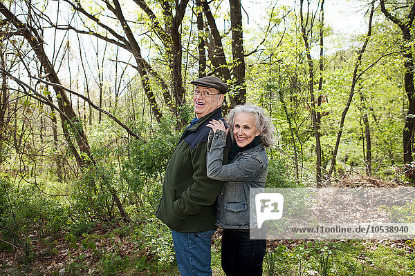 Senior couple standing together in forest  portrait