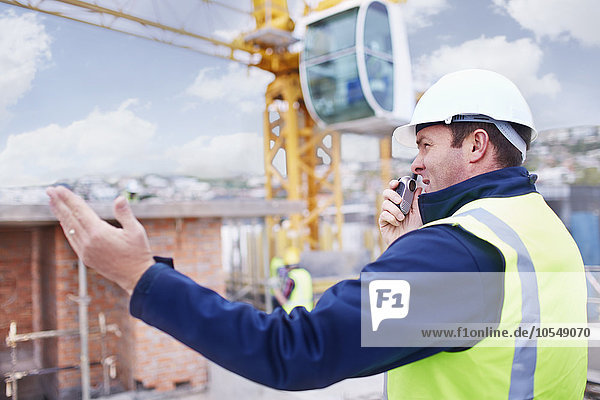 Construction worker with walkie-talkie at construction site