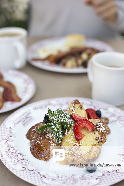 Close up of a plate of food  French toast with berries.