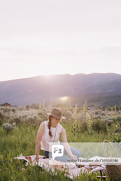 Woman having a picnic on a meadow.
