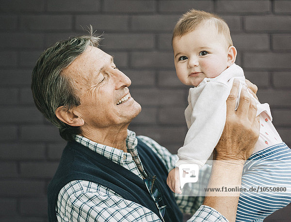 A grandfather and baby granddaughter.