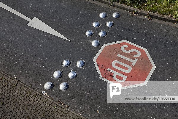 Street with stop sign  directional arrow  Leverkusen  North Rhine-Westphalia  Germany  Europe