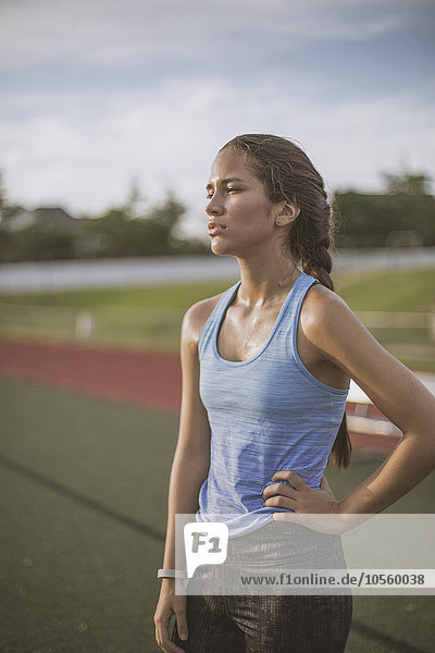 Mixed race athlete standing on sports field