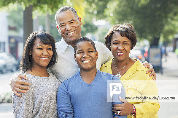 African American family smiling in city
