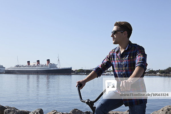 Man riding bicycle at waterfront