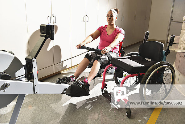 Paraplegic woman working out in physical therapy