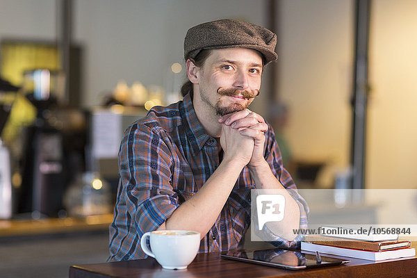 Caucasian man smiling in cafe