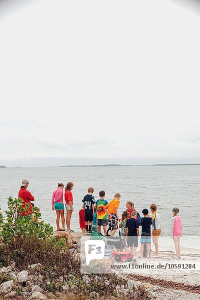 Rear view of large group of children on beach  Sanibel Island  Pine Island Sound  Florida  USA