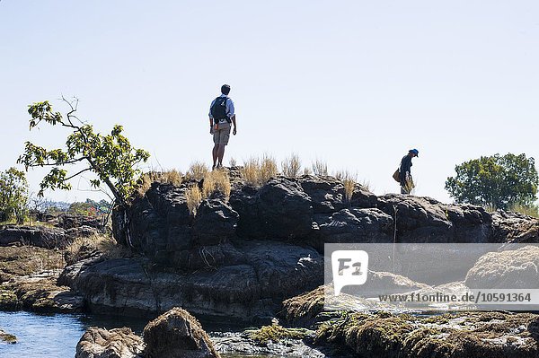 Couple exploring on rocks  near Victoria Falls  Zambia