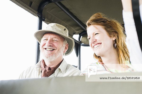 Portrait of senior man and daughter on safari in four wheel drive  Kafue National Park  Zambia