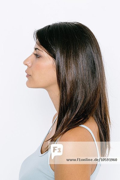 Head and shoulder side profile of young woman wearing vest