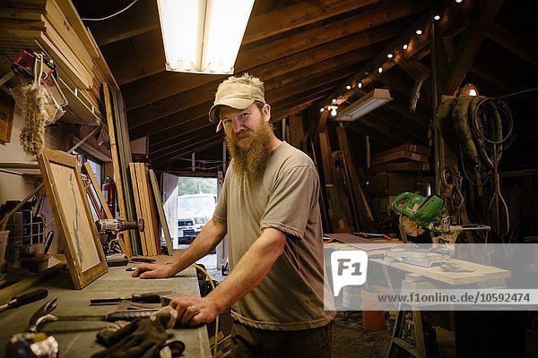 Portrait of wood artist working in workshop
