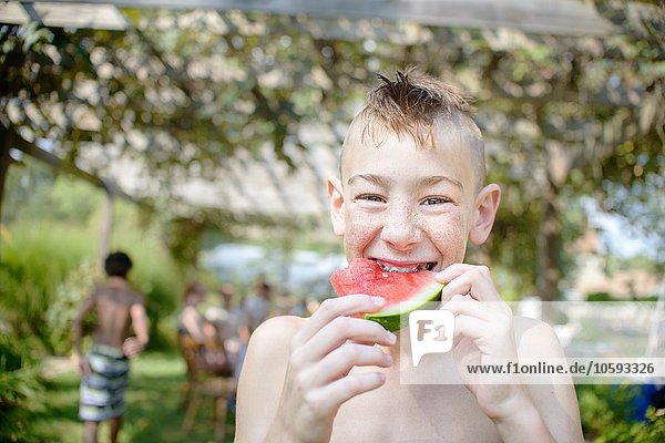 Boy enjoying watermelon at tomato eating festival