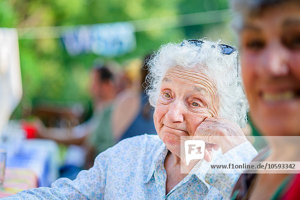 Senior woman daydreaming at tomato eating festival
