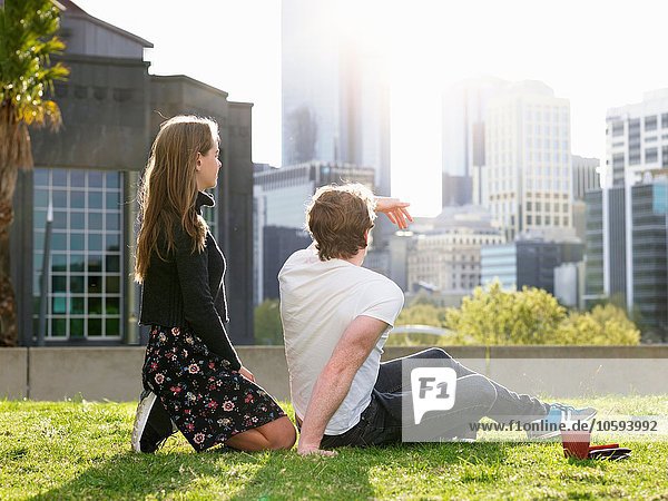 Young couple having coffee break on grass  Melbourne  Victoria  Australia
