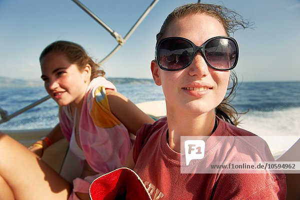 Two teenage girls on boat at sea