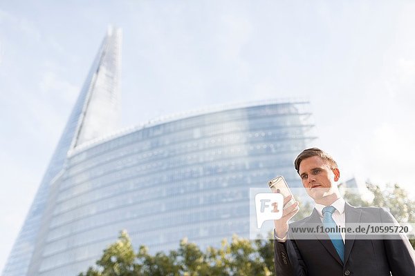 Geschäftsmann beim Telefonieren  Gebäude im Hintergrund  London  UK