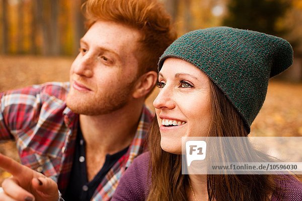 Happy young couple in autumn forest