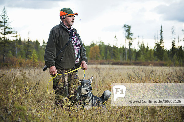 Senior man hunting with dog