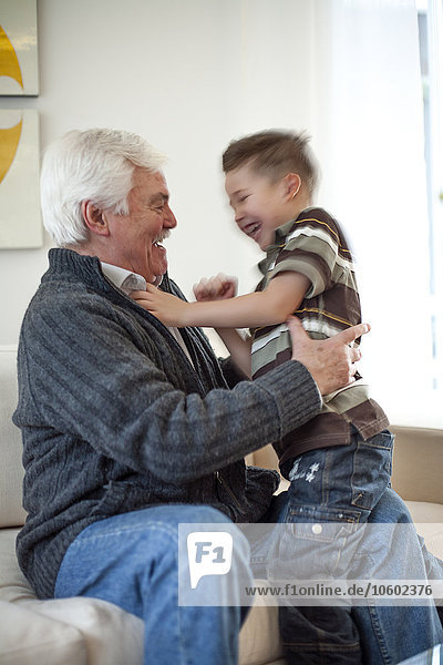 Senior man playing with grandson
