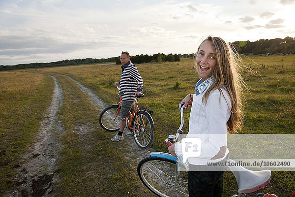 Father with teenage daughter cycling  Oland  Sweden