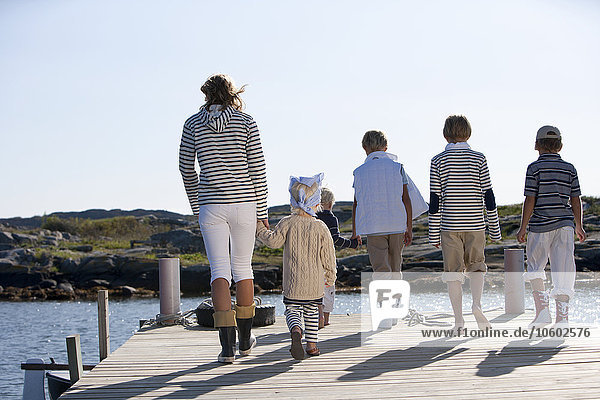Mother with children on jetty  Vastkusten  Sweden