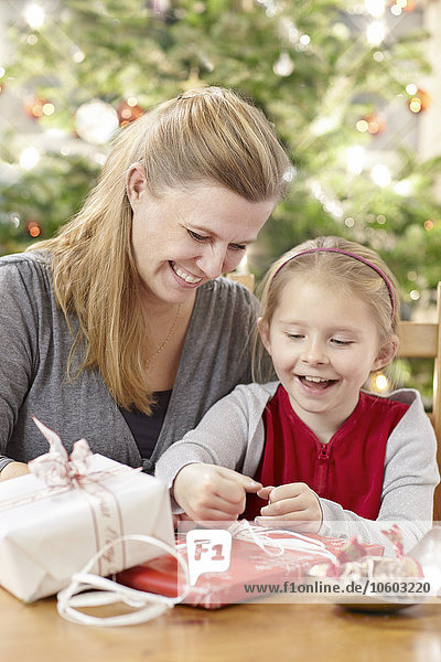 Mother with daughter packing Christmas presents