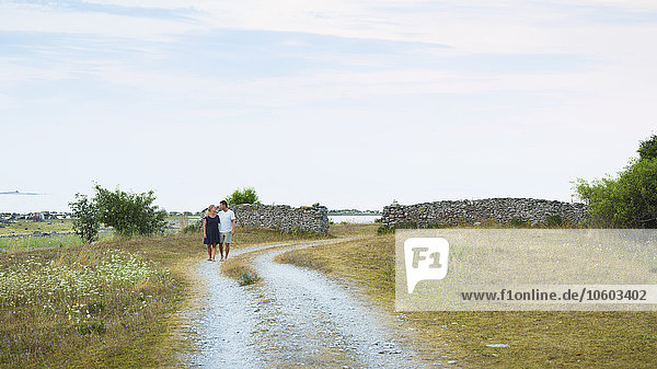 Couple walking through dirt track