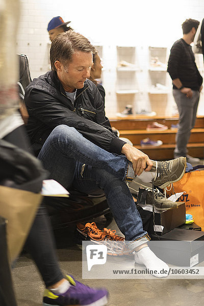 Man trying shoes in shop