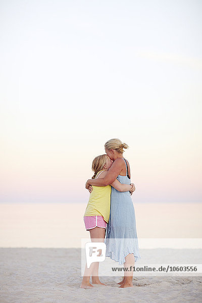 Mother with daughter on beach
