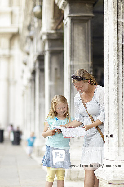 Mother and daughter reading map