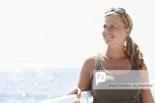 Smiling woman looking at sea