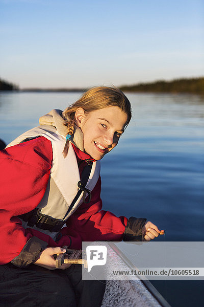 Teenage girl fishing on boat