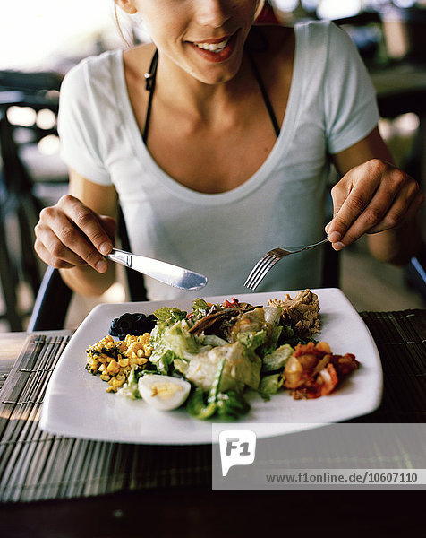 A Scandinavian woman having lunch  Thailand.