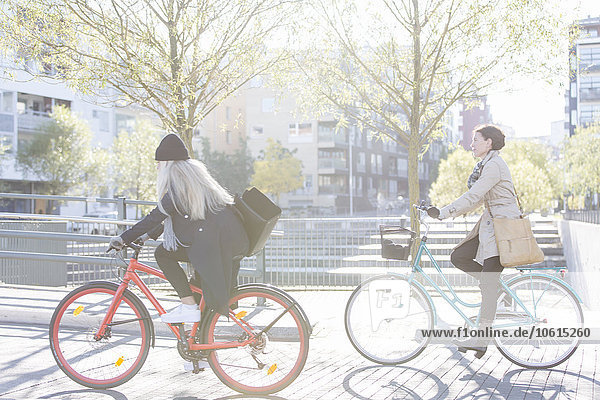 Women riding bicycles in city