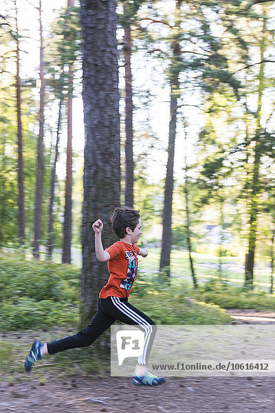 Boy running in forest