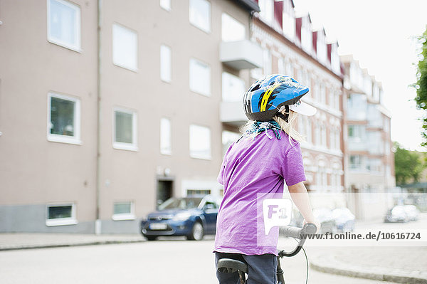 Girl cycling in street