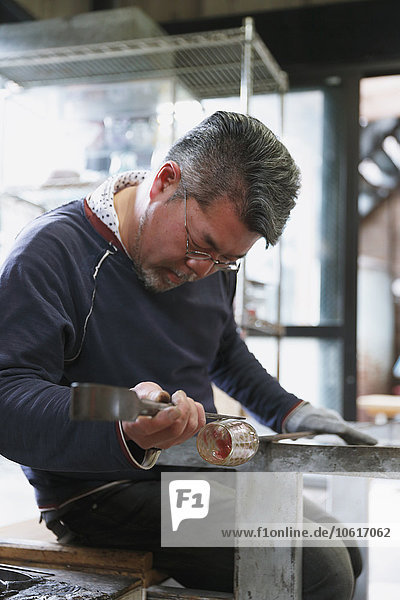 Japanese glass artisan working in the studio