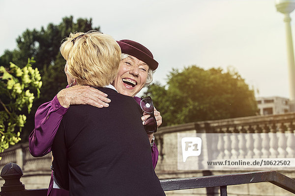 Deutschland  Berlin  Porträt von zwei glücklichen Seniorinnen  die sich umarmen
