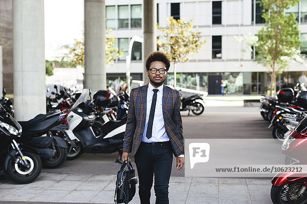 Young businessman walking outdoors