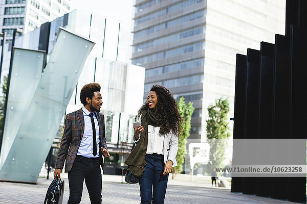 Two young business people walking outdoors
