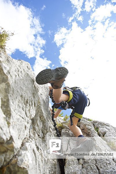 Austria  Tyrol  Rofan mountains  boy climbing
