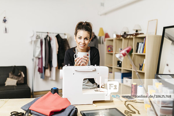 Young fashion designer working in her studio