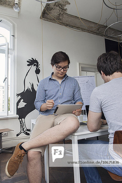Two creative businessmen working in a modern office